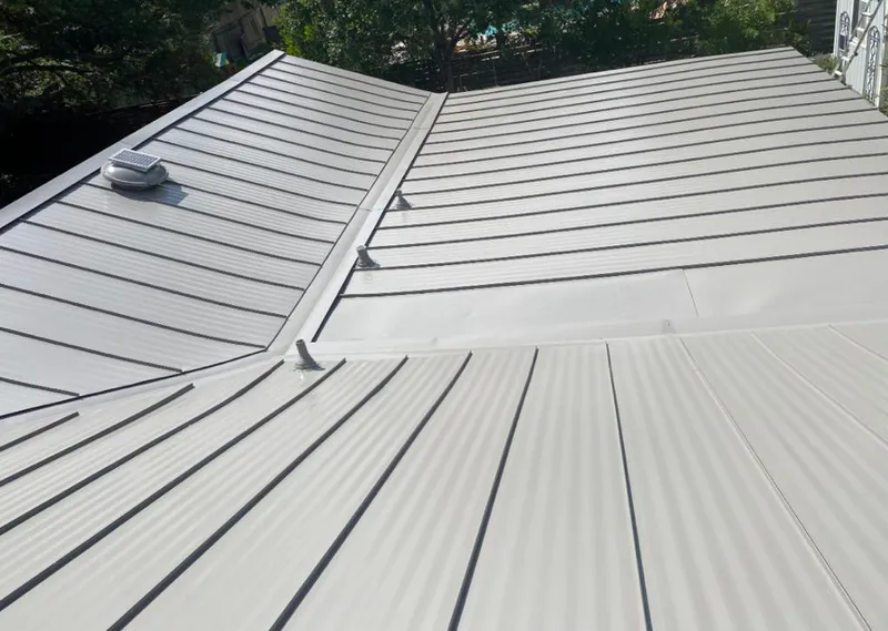 Solar attic fan installed on a metal roof for Roof Ventilation in Hewitt